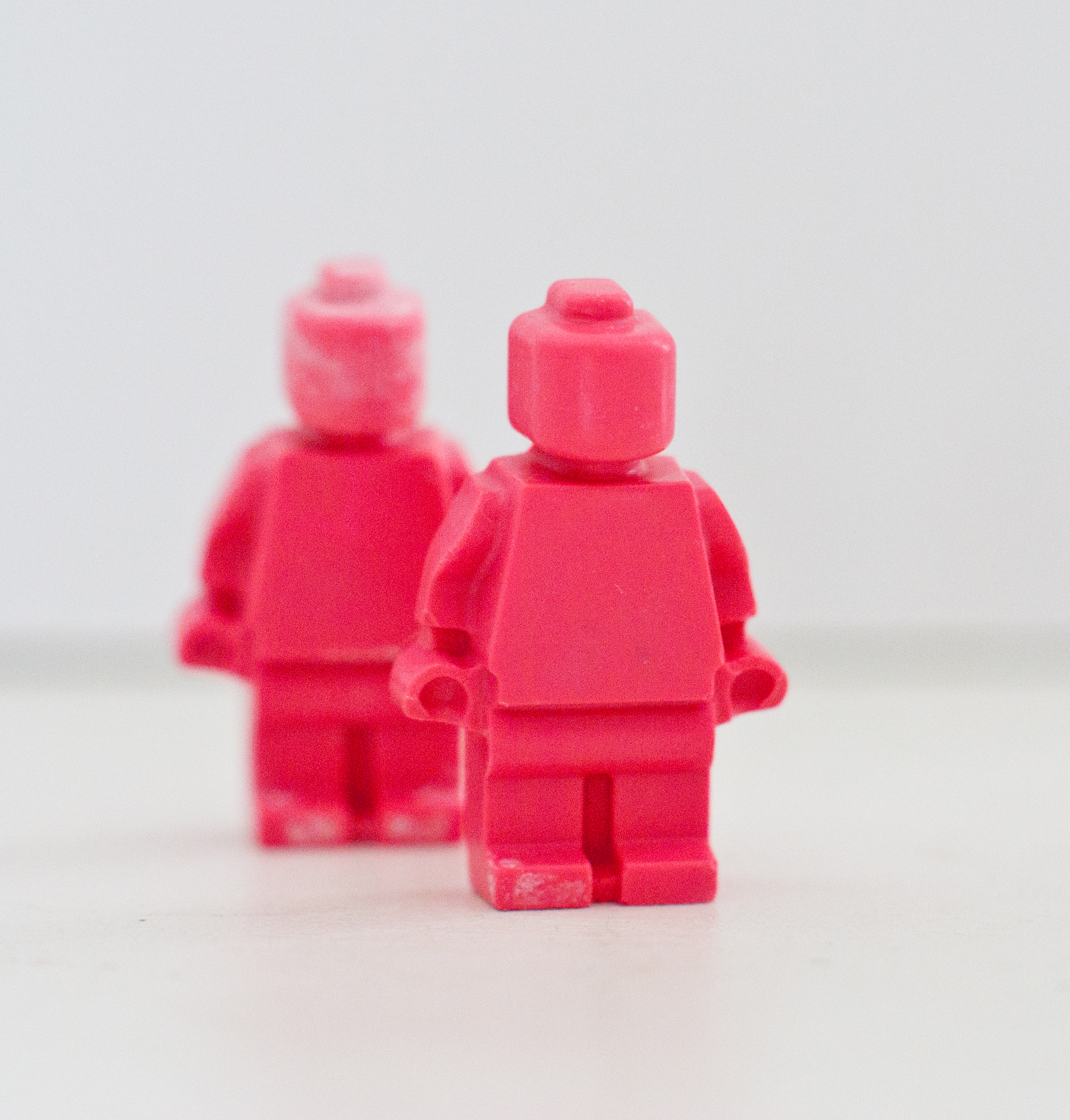 Lego minifigure in a pink crayon costume on Craiyon