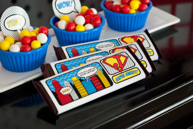 Vintage comic book birthday party setup with colorful superhero desserts and printable decor