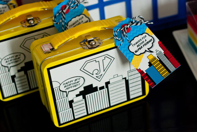 Vintage comic book birthday party setup with colorful superhero desserts and printable decor