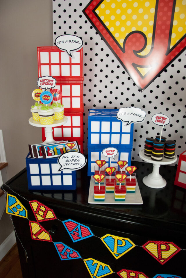 Vintage comic book birthday party setup with colorful superhero desserts and printable decor