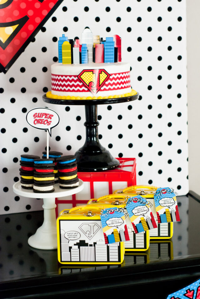 Vintage comic book birthday party setup with colorful superhero desserts and printable decor