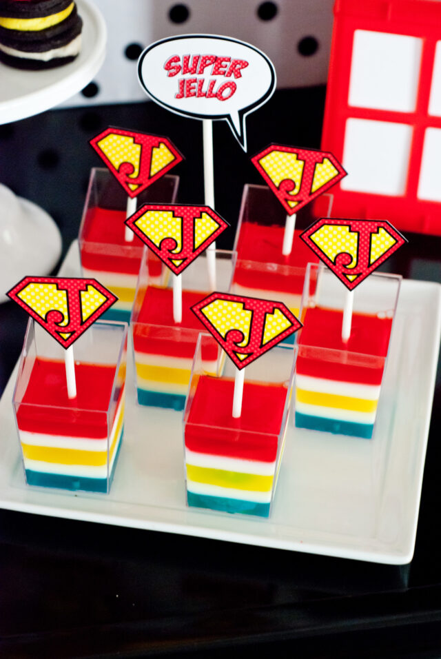 Vintage comic book birthday party setup with colorful superhero desserts and printable decor