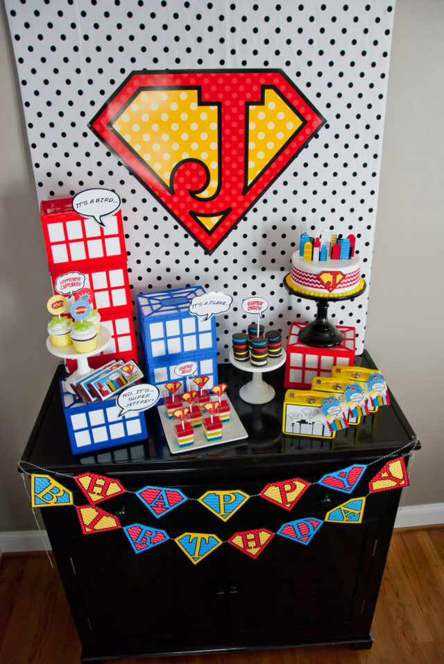 Vintage comic book birthday party setup with colorful superhero desserts and printable decor