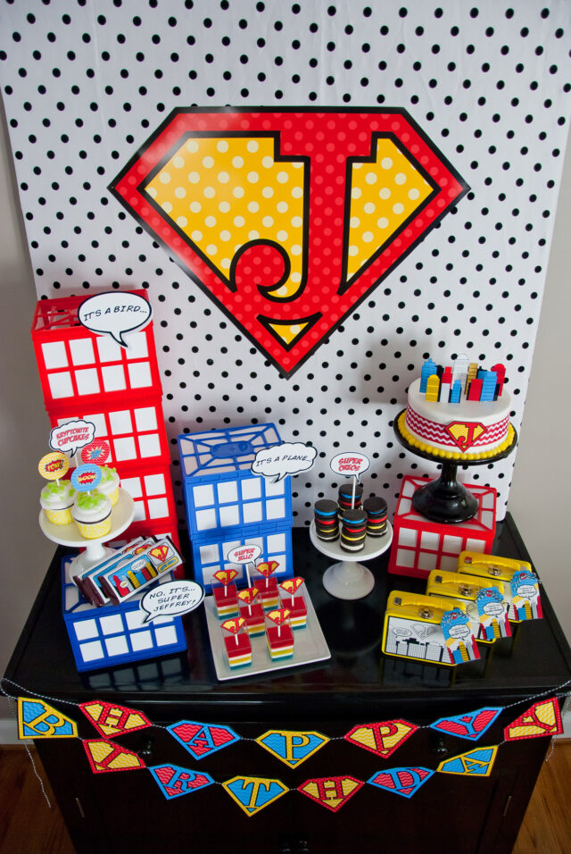 Vintage comic book birthday party setup with colorful superhero desserts and printable decor