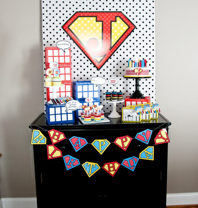 Vintage comic book birthday party setup with colorful superhero desserts and printable decor