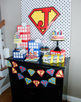 Vintage comic book birthday party setup with colorful superhero desserts and printable decor