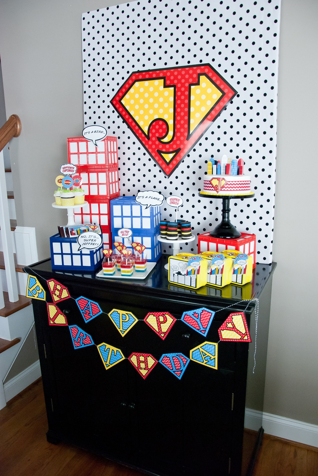 Vintage comic book birthday party setup with colorful superhero desserts and printable decor