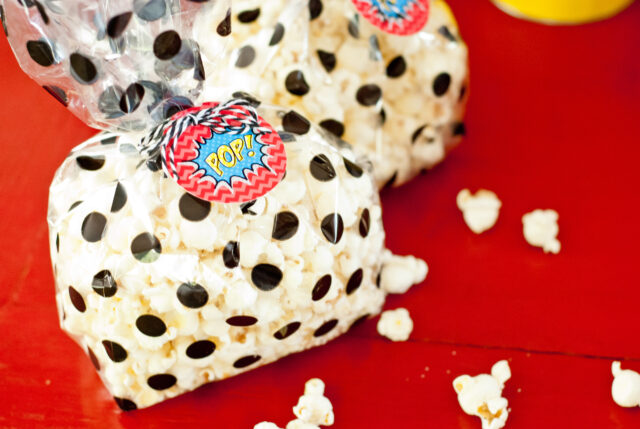 Vintage comic book birthday party setup with colorful superhero desserts and printable decor