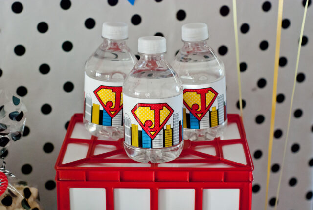 Vintage comic book birthday party setup with colorful superhero desserts and printable decor