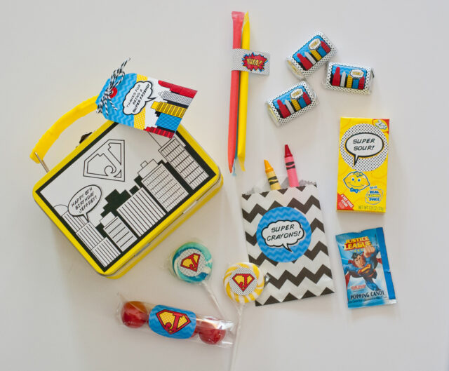 Vintage comic book birthday party setup with colorful superhero desserts and printable decor