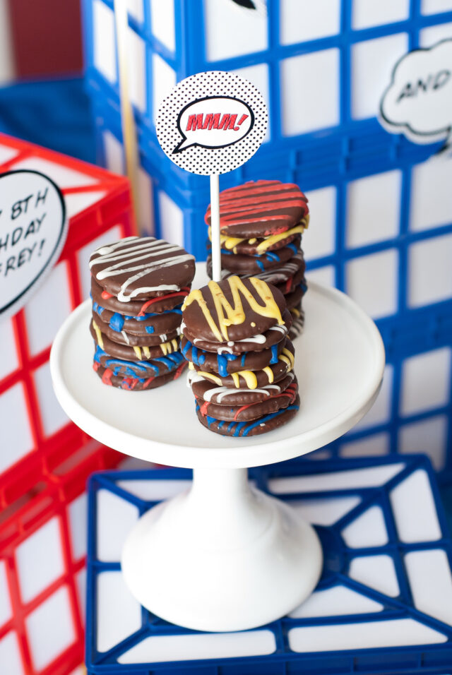 Vintage comic book birthday party setup with colorful superhero desserts and printable decor