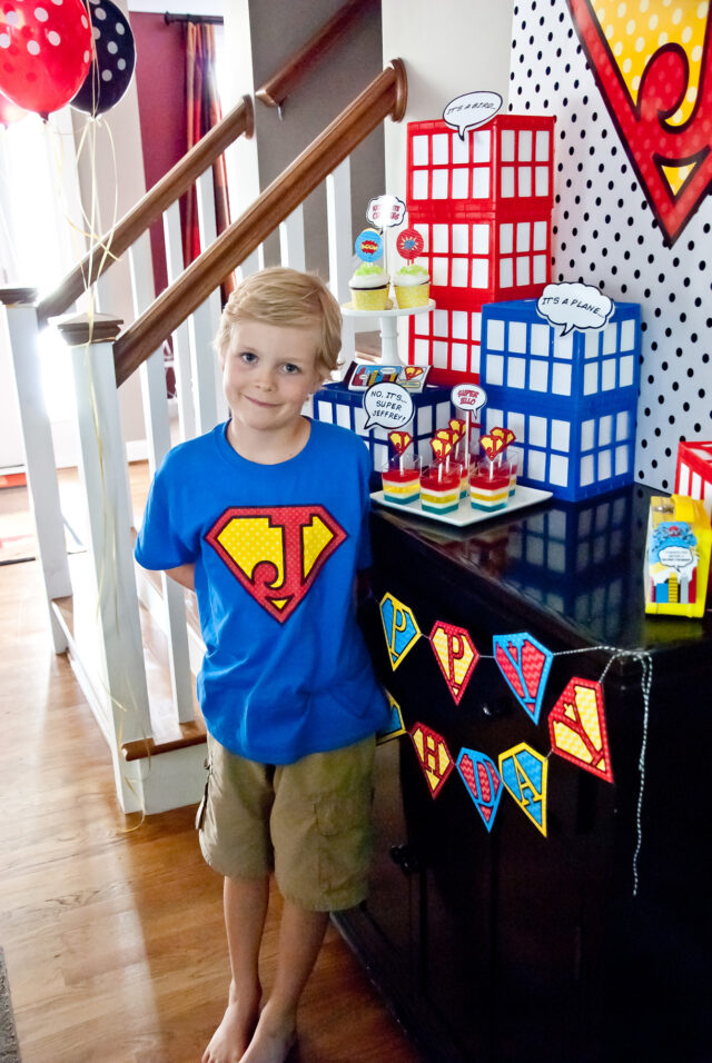 Vintage comic book birthday party setup with colorful superhero desserts and printable decor
