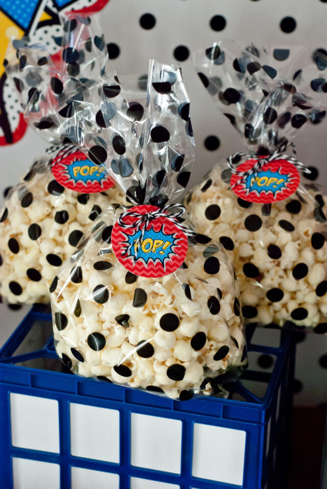 Vintage comic book birthday party setup with colorful superhero desserts and printable decor