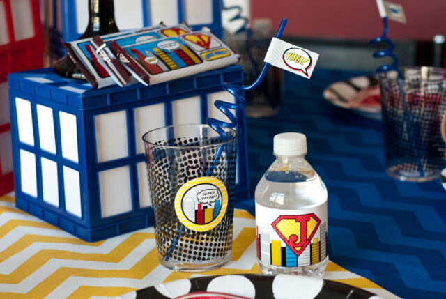 Vintage comic book birthday party setup with colorful superhero desserts and printable decor