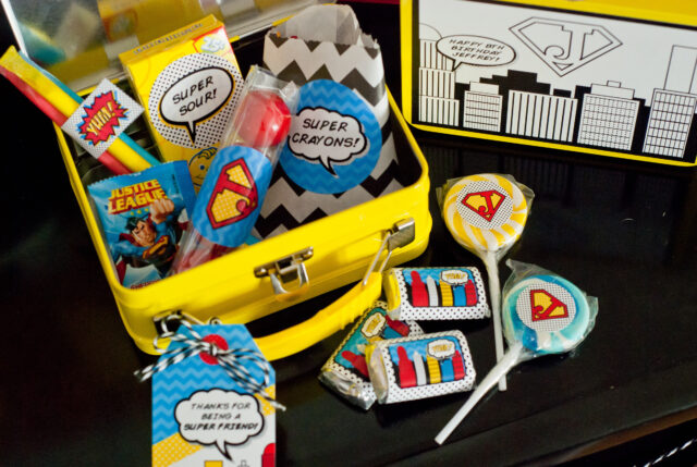 Vintage comic book birthday party setup with colorful superhero desserts and printable decor