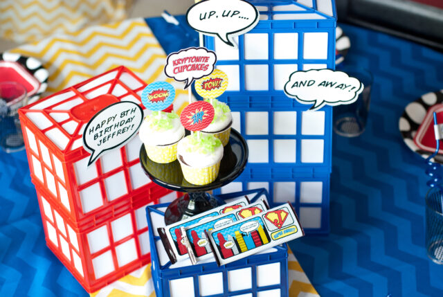 Vintage comic book birthday party setup with colorful superhero desserts and printable decor