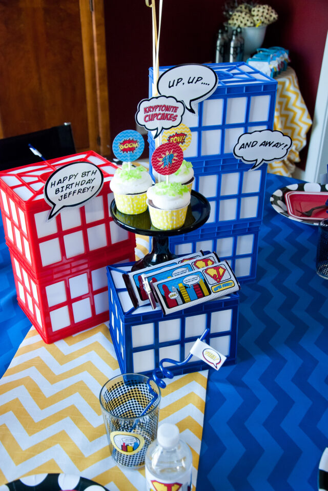 Vintage comic book birthday party setup with colorful superhero desserts and printable decor