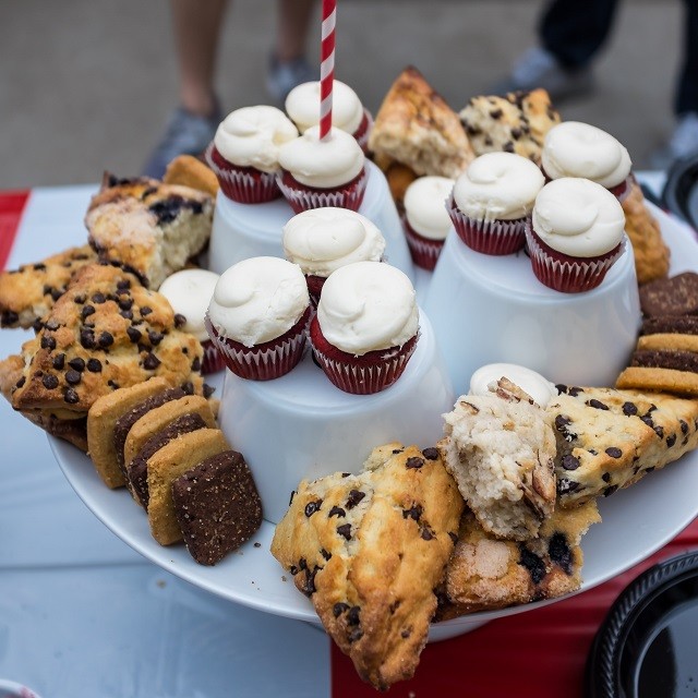 Dessert table had cupcakes, scones, and tea biscuits