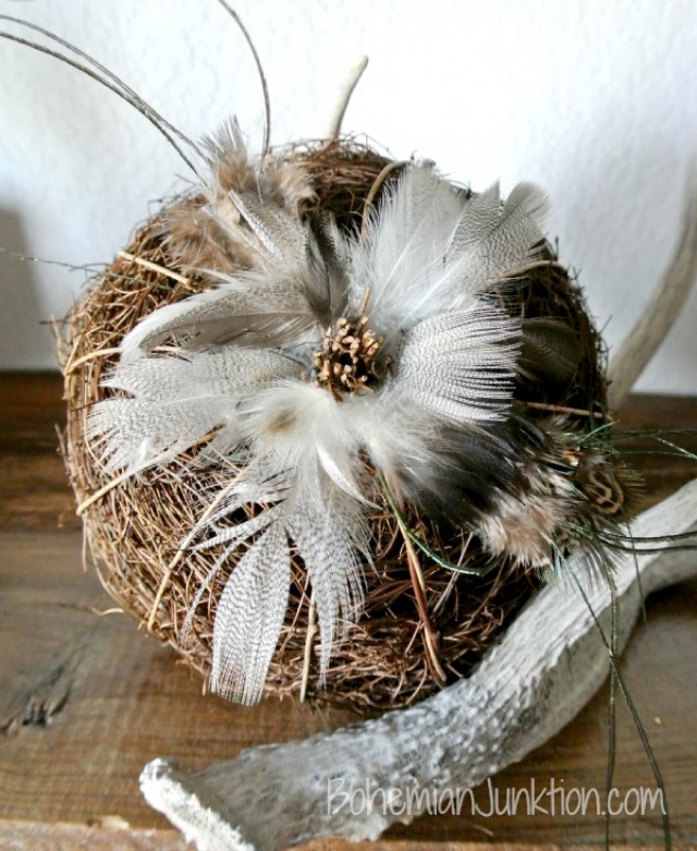 rustic pumpkin with twigs and feathers